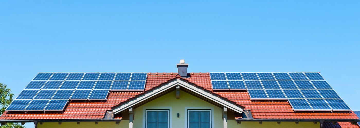 Picture of top of a house with solar panels on the roof.