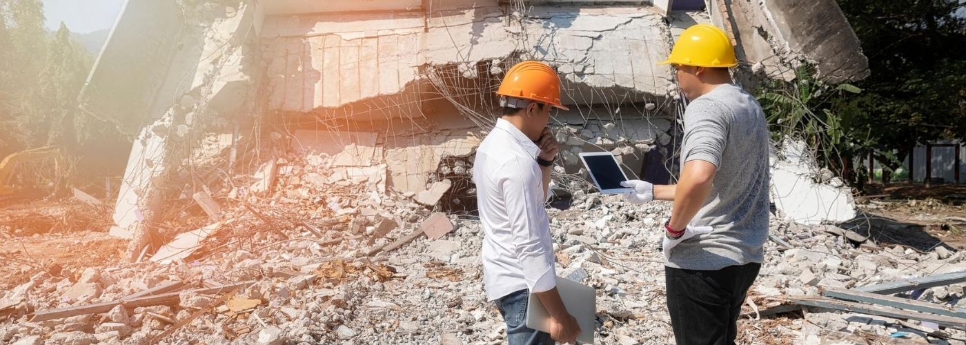 Construction workers walking in rubble